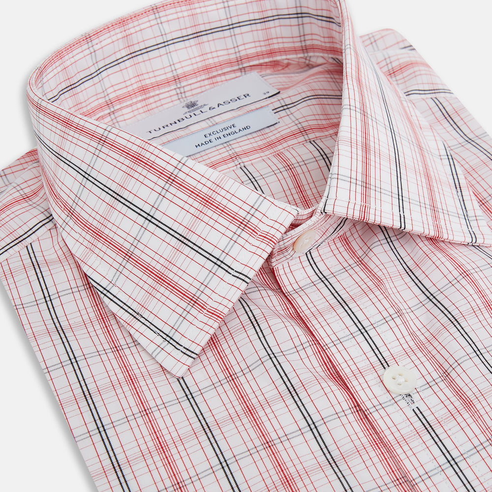 The Turnbull & Asser Red Multi Check Mayfair Shirt is a long-sleeve, button-up with a collar, crafted from Italian cotton and featuring a red multi check plaid pattern on white, shown laid flat against a white surface.