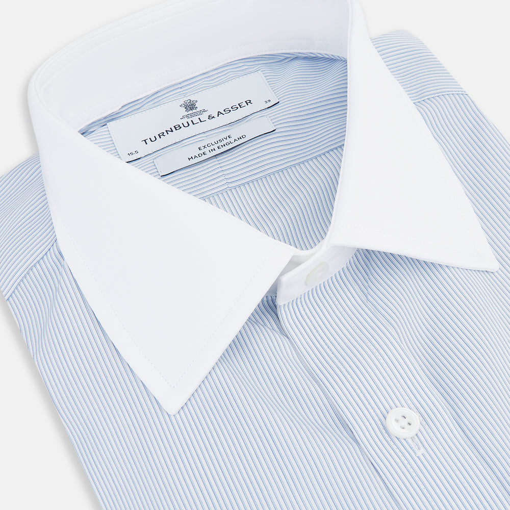 The Turnbull & Asser Sky Blue Hairline Multi Stripe Shirt features a contrast T&A collar and cuffs in white, Mayfair fit, and front buttons, displayed on a plain white background.