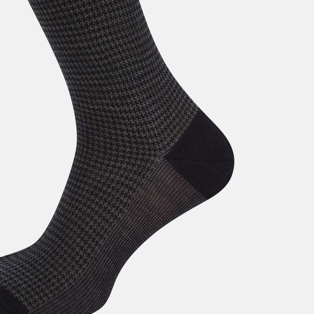 The Turnbull & Asser Charcoal Melange Houndstooth Mid-Length Sock features a black toe, heel, and cuff, and is shown singly against a plain white background.