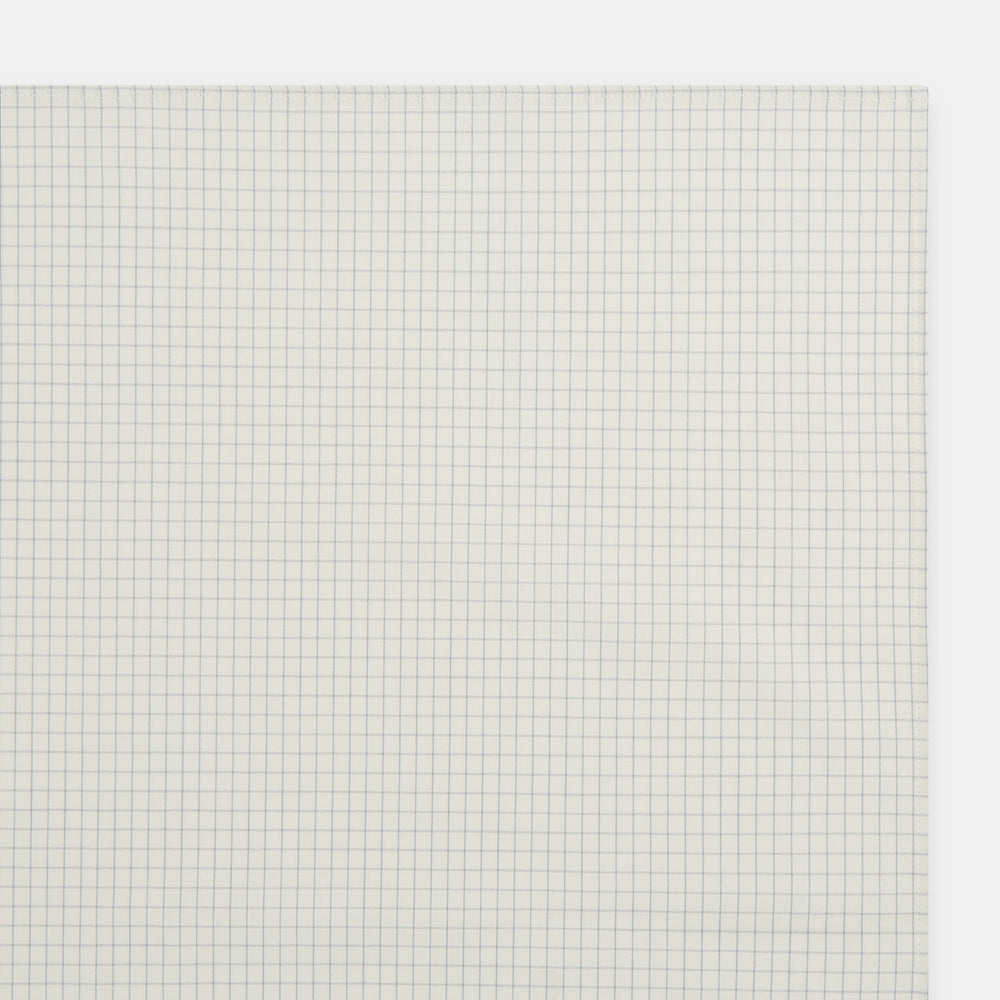 The Turnbull & Asser Pale Blue Graph Check Handkerchief features a refined white background with evenly spaced pale blue grid lines, evoking the minimalist elegance of classic graph paper in a luxurious accessory.