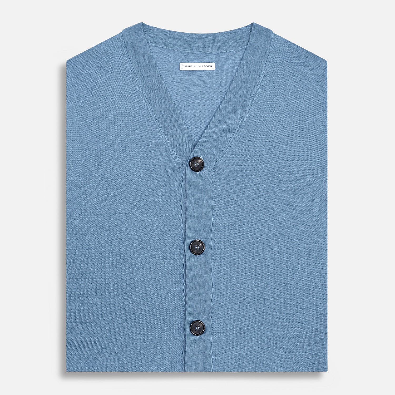 View 4 of product Turnbull & Asser’s Pale Blue Merino V-neck Sleeveless Cardigan features a button-up front, two pockets, and ribbed hem—a classic gentleman’s piece shown on a plain white background.