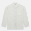 View 4 of product The Turnbull & Asser Cream Silk Pyjama Set, shown laid flat on a white background, features a long-sleeve button-up top with a chest pocket and matching pants with an elastic drawstring waist—ideal for comfortable loungewear.