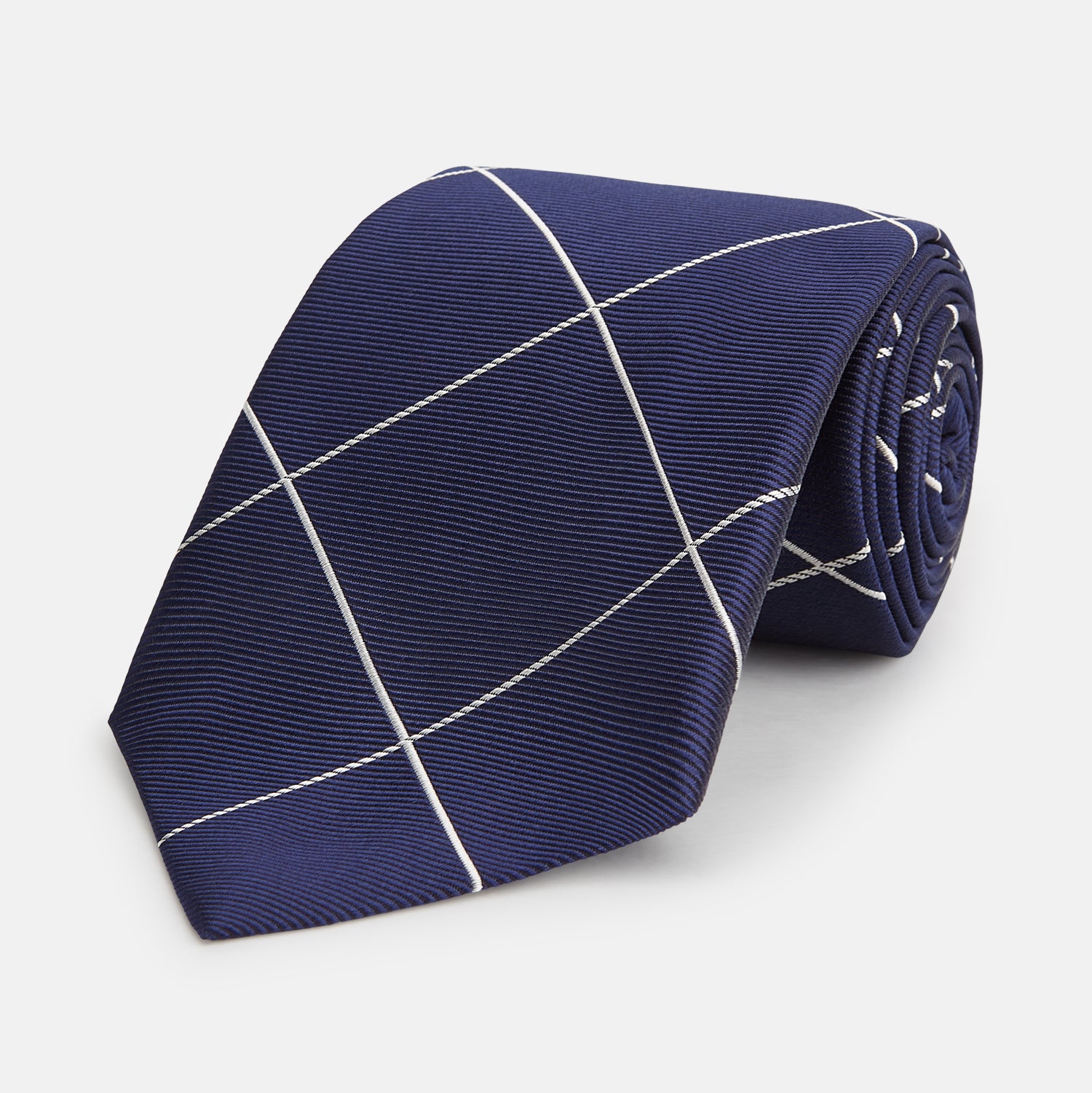 View 1 of product The Turnbull & Asser WINDOW PANE NAVY WHITE TIE features navy blue silk with a subtle diagonal ribbed texture and white windowpane checks, making it the perfect men’s accessory for any formal occasion.