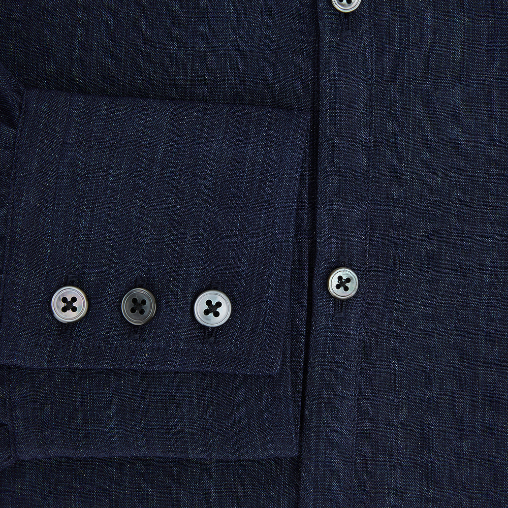 The Navy Linen Westminster Shirt by Turnbull & Asser features a classic collar and buttoned cuffs, exemplifying British craftsmanship. Shown here in long sleeves, the shirt is displayed flat against a white background.