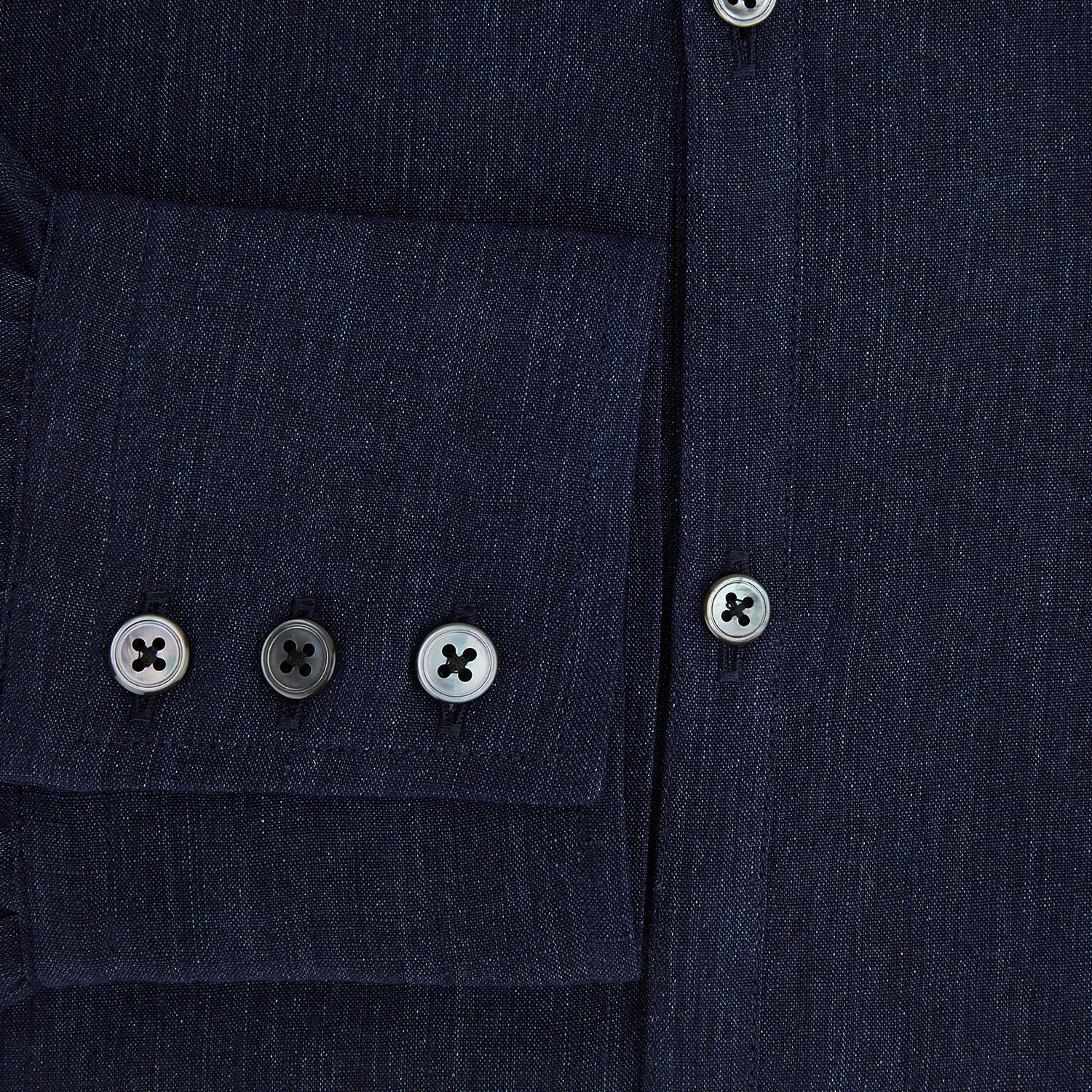 View 4 of product The Navy Linen Westminster Shirt by Turnbull & Asser features a classic collar and buttoned cuffs, exemplifying British craftsmanship. Shown here in long sleeves, the shirt is displayed flat against a white background.