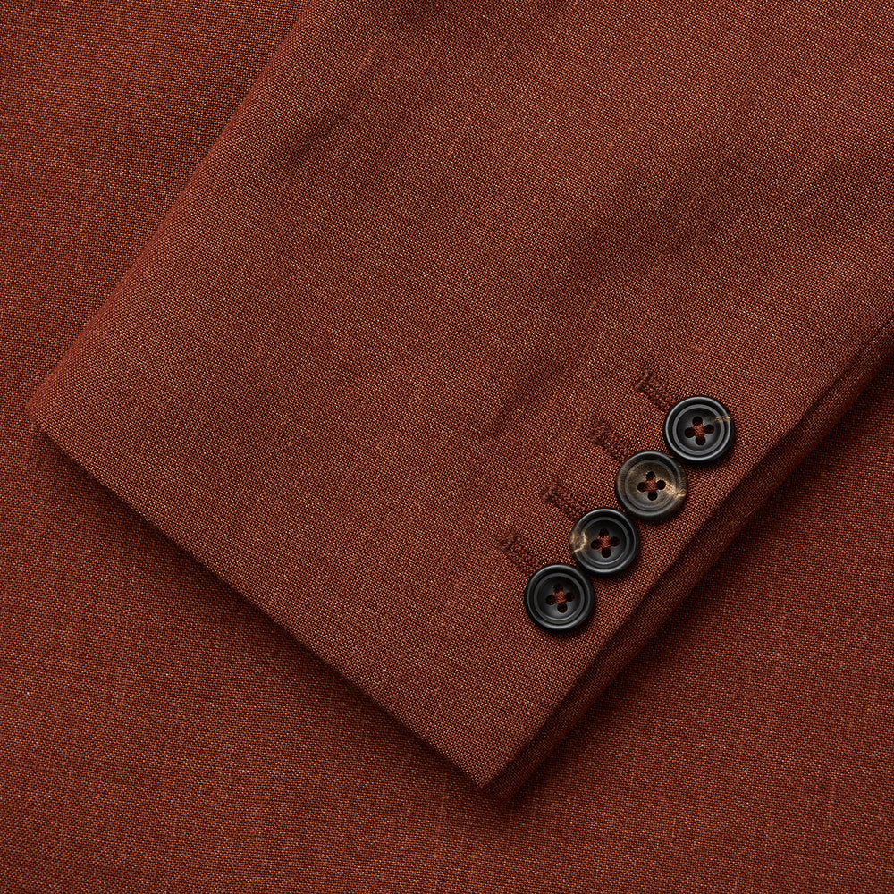 The Turnbull & Asser Rust Linen-Wool-Silk Bertie Blazer is a red double-breasted jacket with peak lapels, black buttons, and flap pockets, tailored in Italy from a luxury linen-wool-silk blend and shown on a white background.