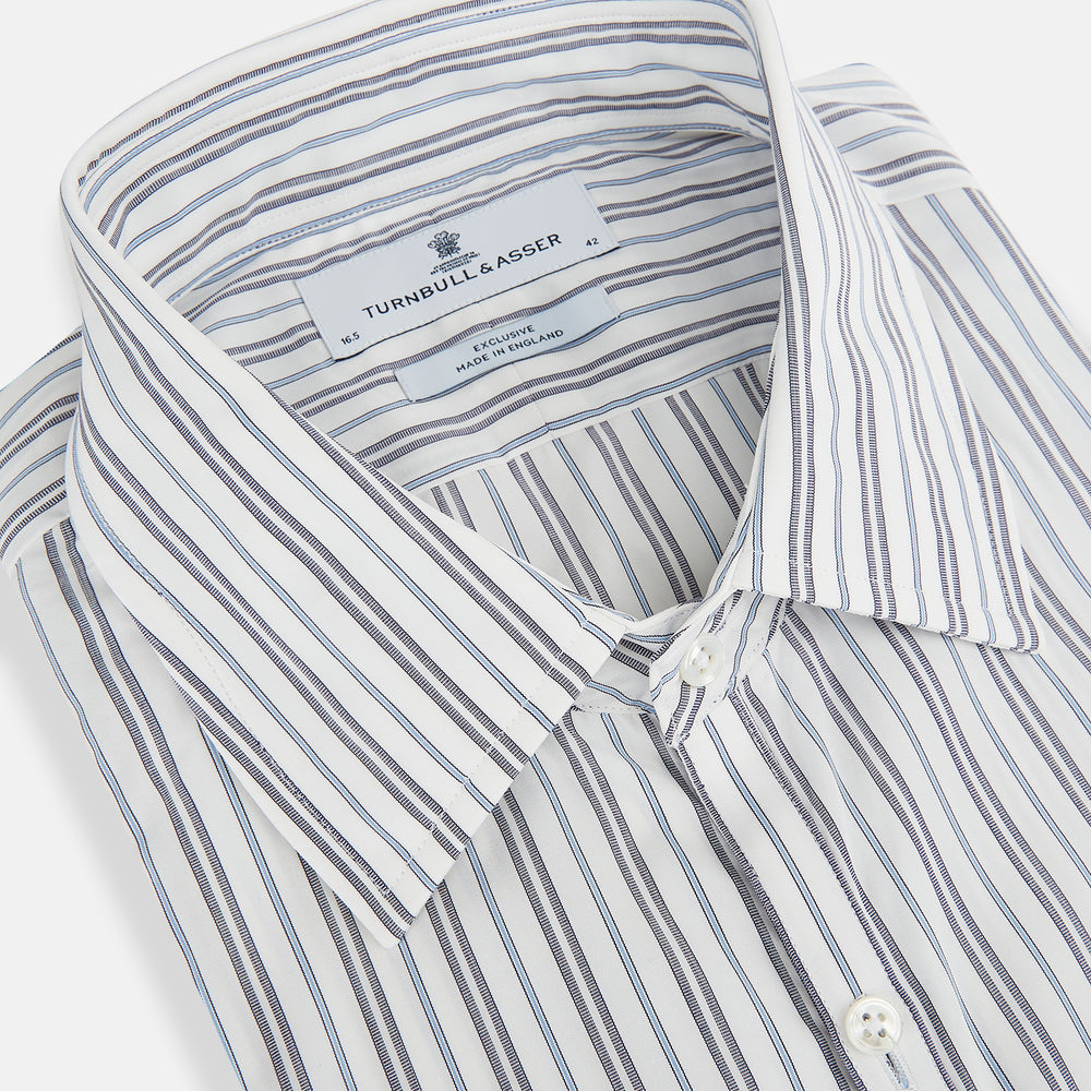 The Turnbull & Asser Navy and Light Blue Multi Track Stripe Westminster Shirt, featuring a button-up design with long sleeves and a signature collar, is displayed flat to highlight its expert British craftsmanship.