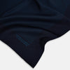 View 2 of product The Navy and Blue Stripe Silk Pocket Square by Turnbull & Asser features vertical blue pinstripes, is crafted from silk with hand-rolled edges, and is finished with the brand's logo printed in blue at the lower right corner.