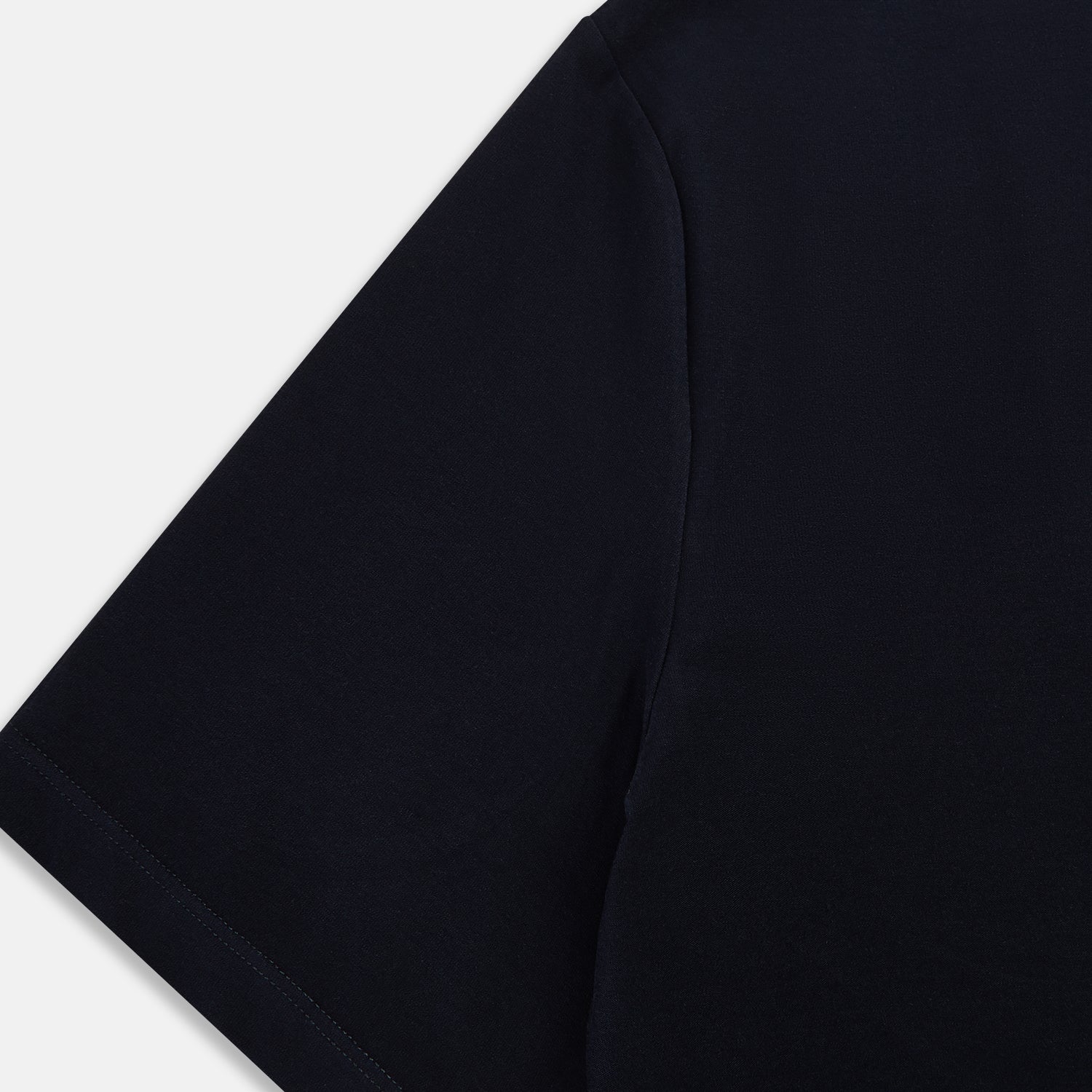 Image 4 of product A navy short-sleeve pyjama shirt by Turnbull & Asser is laid flat on a white background, displaying the front view. Its soft fabric ensures comfort with no visible logos, designs, or patterns on the shirt.