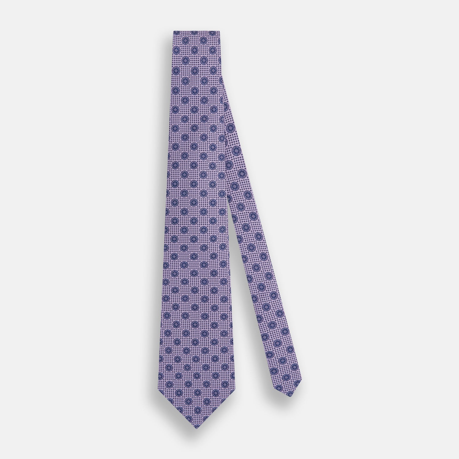 View 2 of product The Turnbull & Asser Lilac Medallion Printed Silk Tie is crafted from English silk with a geometric motif of small blue circles and a subtle checkered background.