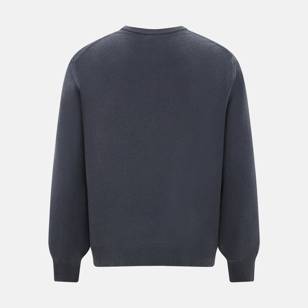 The Turnbull & Asser Grey Cashmere Round Neck Jumper is shown against a light gray background, featuring a relaxed fit with ribbed cuffs, collar, and hem for an elegant look.