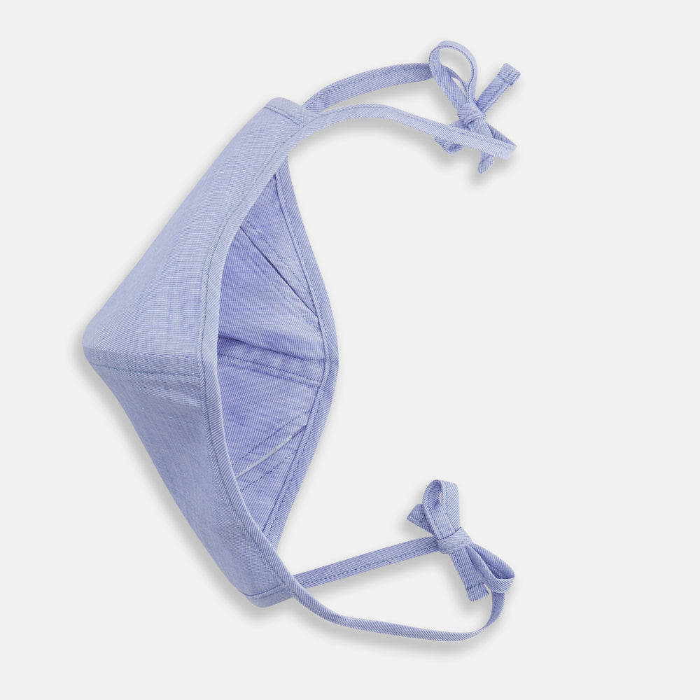 The Turnbull & Asser Plain Pale Blue Commuter Mask with 3 Viroformula™ filters features adjustable ear loops and side ties—ideal for daily use, shown against a white background.