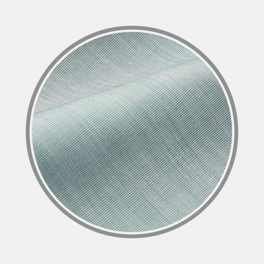 Close-up view of Plain Green Cotton Fabric by Turnbull & Asser, highlighting fine diagonal weave and texture, framed within a circular border on a white background.