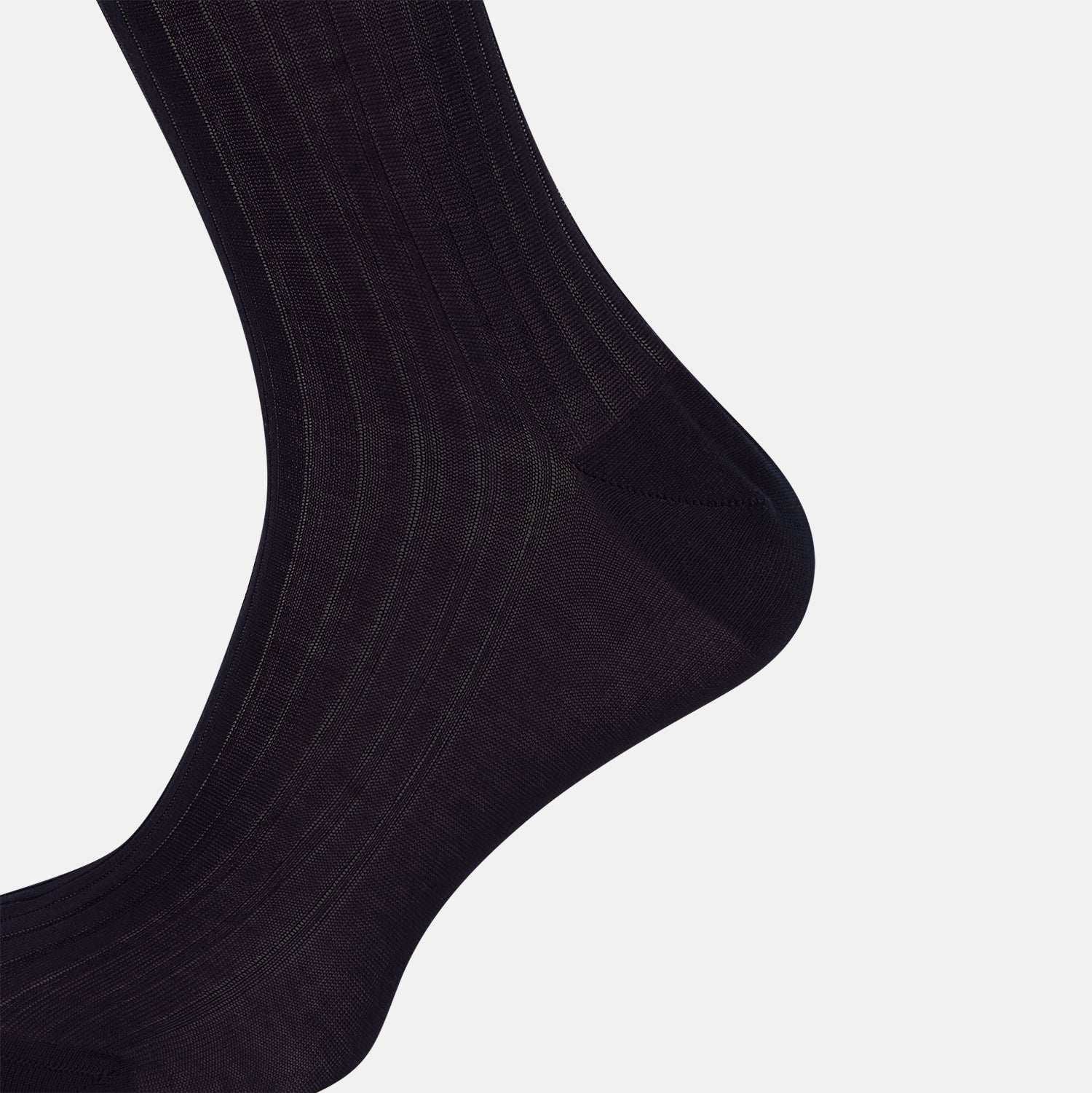 View 4 of product A single Midnight Mid-length Sock by Turnbull & Asser, made from mercerised Egyptian cotton, stands upright on a white background. This luxury black sock features a ribbed texture with smooth toe and heel areas.