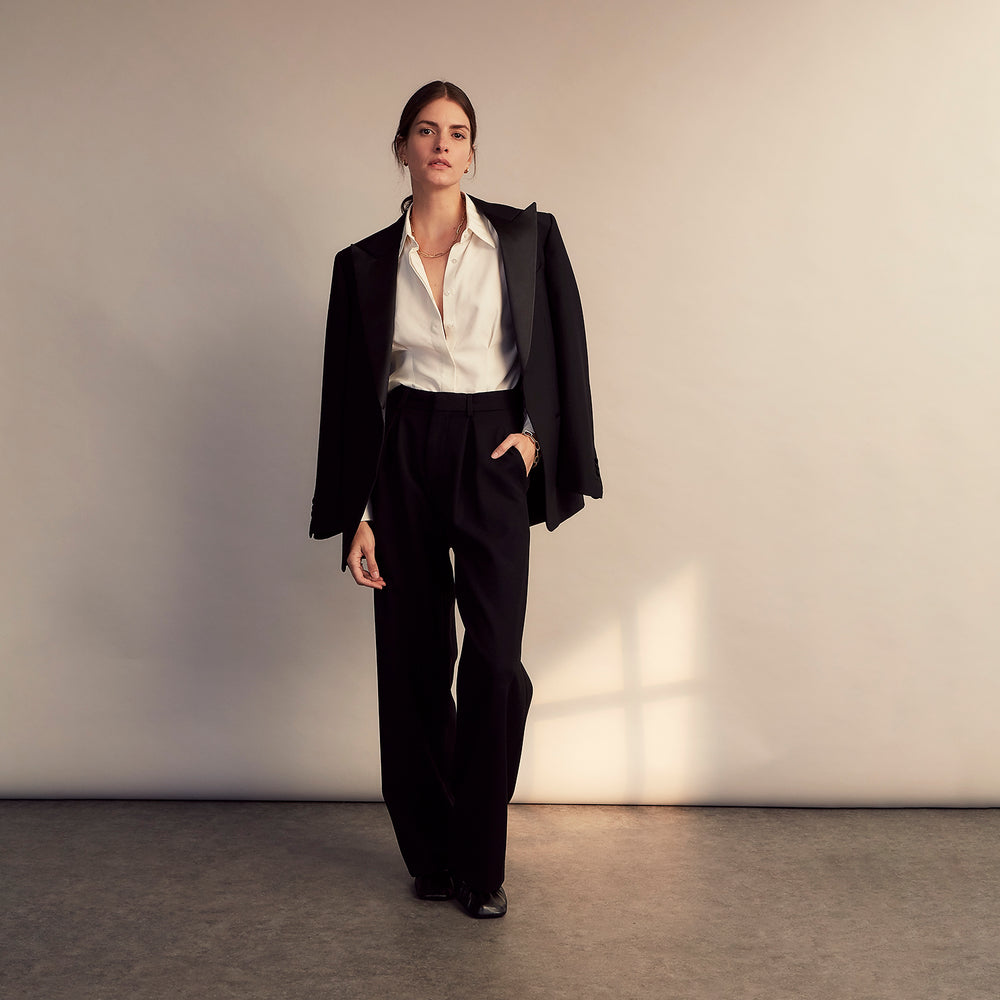 The Cream Silk Tailored Bianca Shirt by Turnbull & Asser features long sleeves, a pointed collar, and curved hem in soft-touch peace silk with a tailored fit. Shown laid flat on a white background.