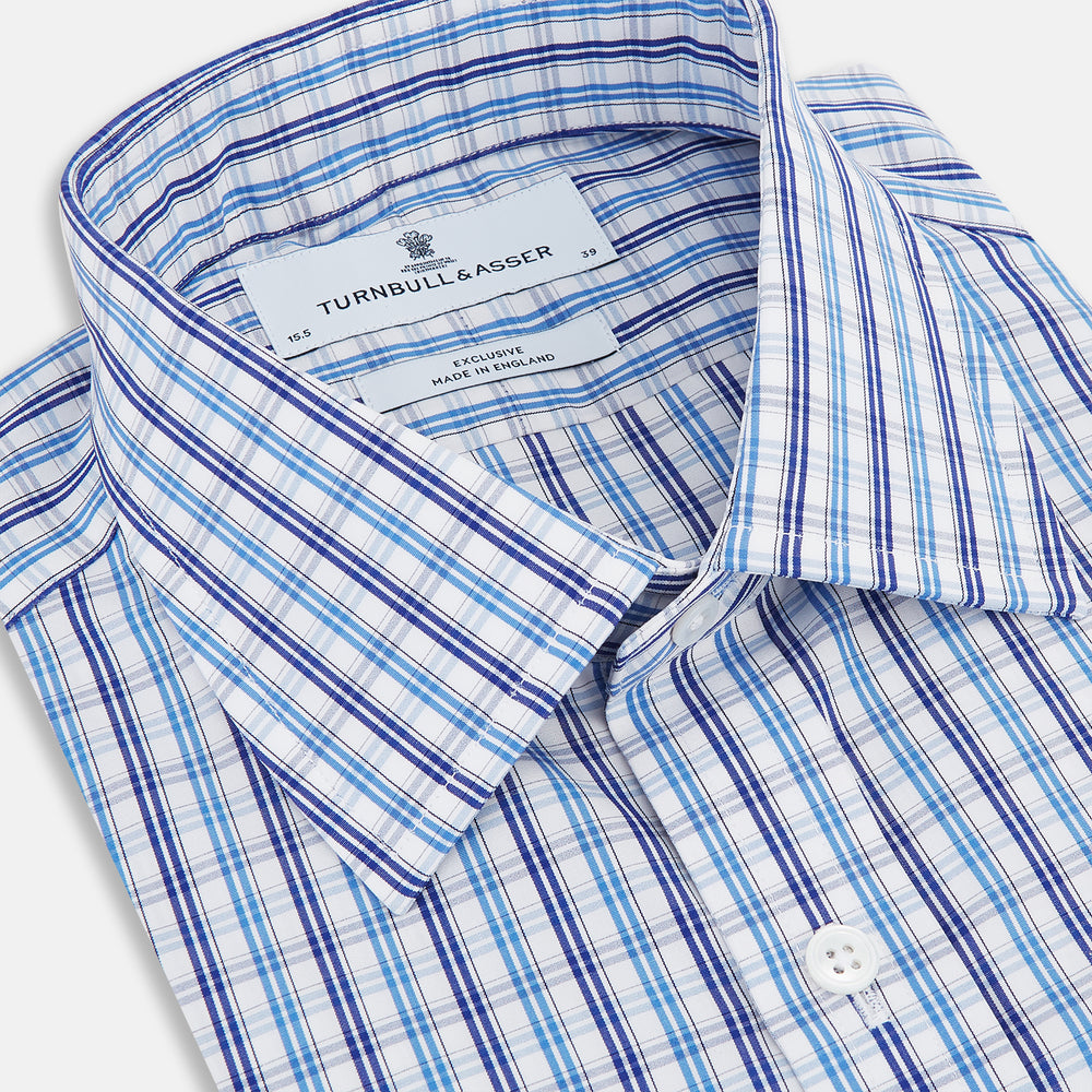 The Turnbull & Asser Blue and Navy Multi Check Mayfair Shirt, made from fine Italian cotton with long sleeves, a button-up front, and a classic collar, is shown against a white background.