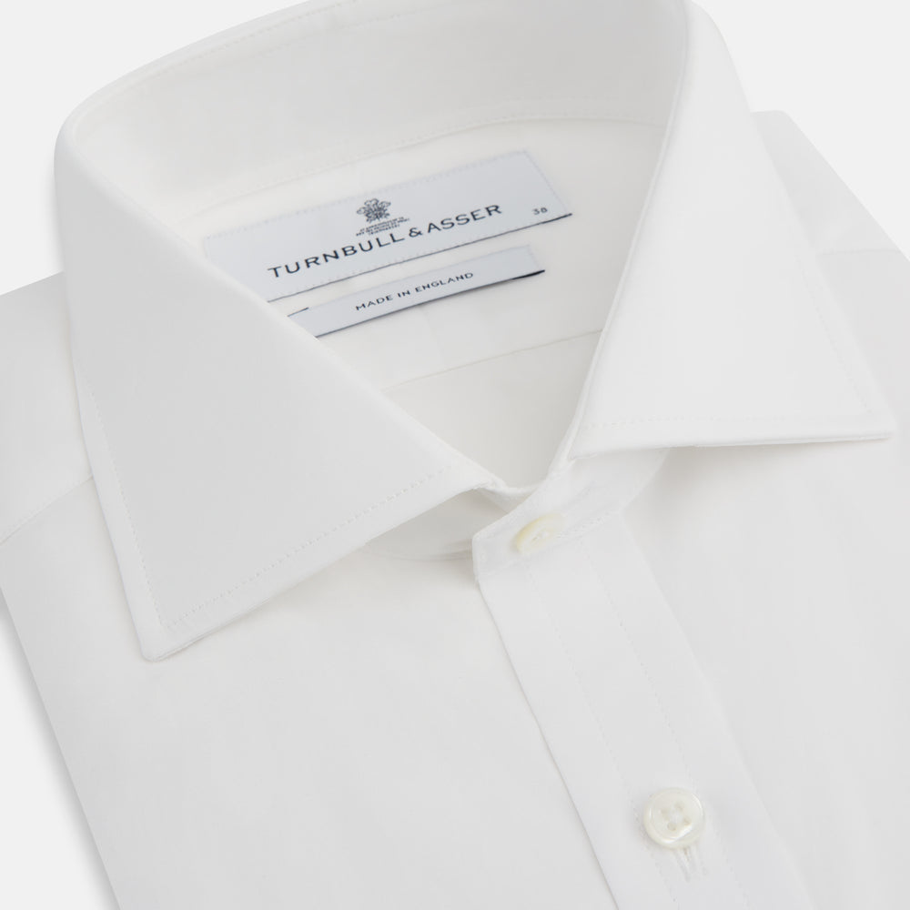 The Turnbull & Asser White Poplin Shirt features a regent collar, button-down front, and 2-button cocktail cuffs, shown against a plain white background.