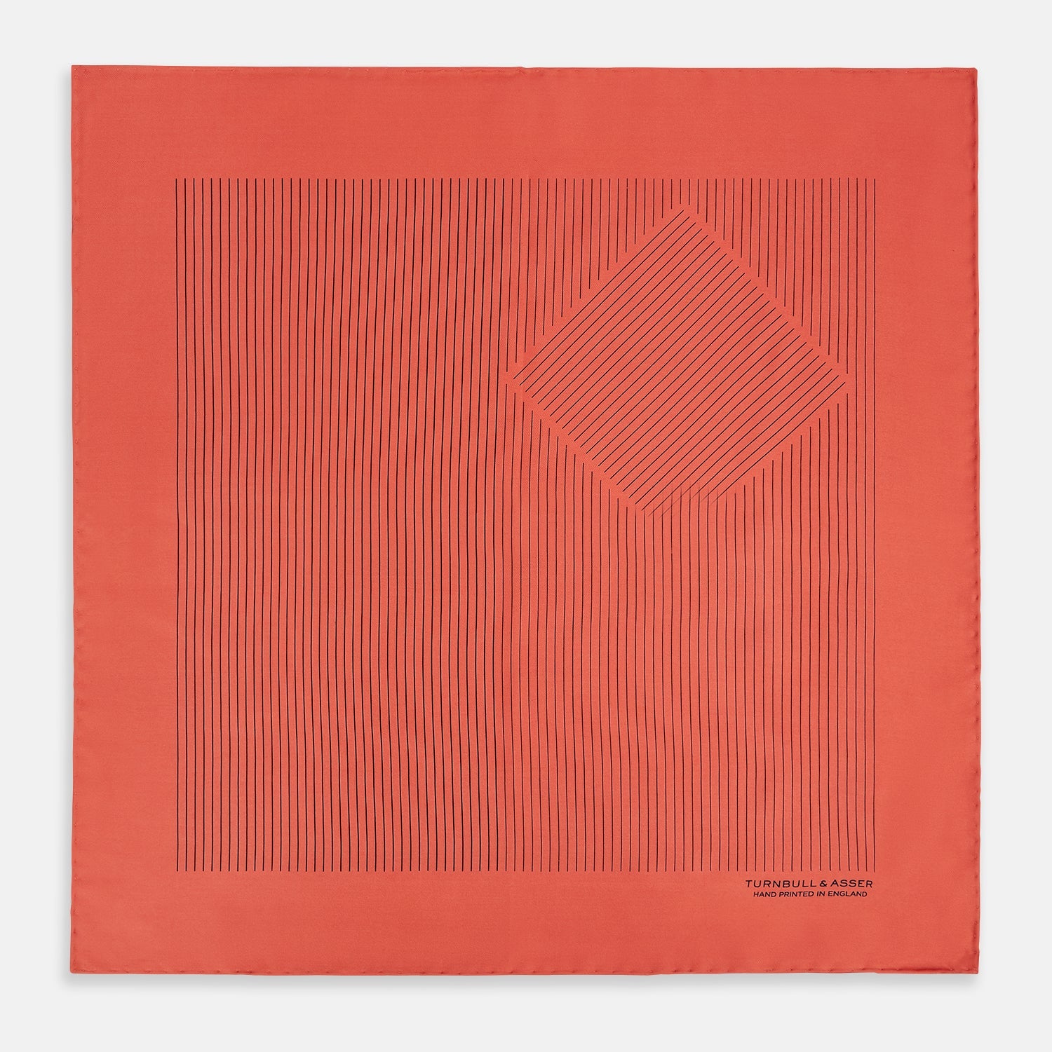 View 4 of product The Orange Stripe Silk Pocket Square by Turnbull & Asser features thin black vertical lines and "TURNBULL & ASSER HAND PRINTED IN ENGLAND" in the corner, neatly folded on a white background.
