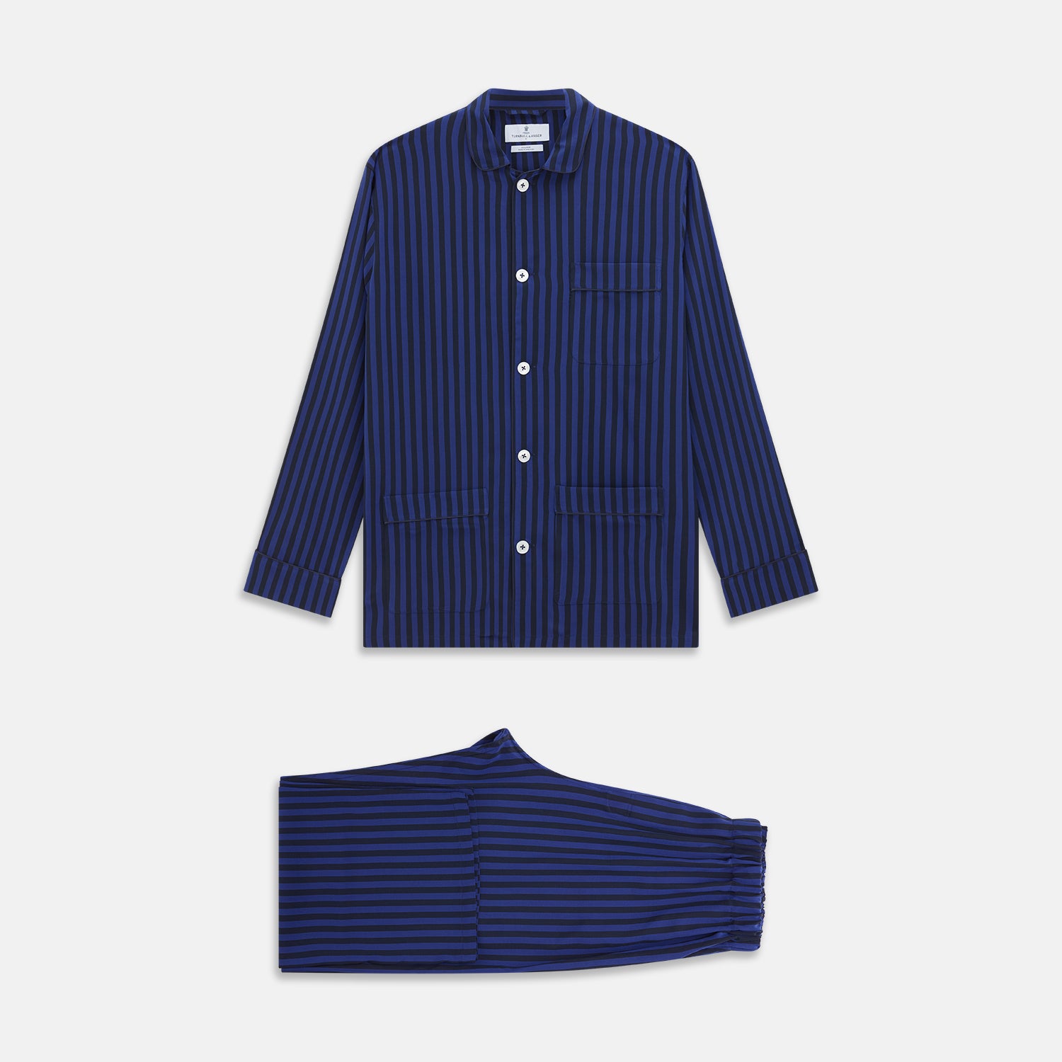 View 1 of product The Turnbull & Asser Blue and Navy Candy Stripe Silk Hyde Pyjamas Set features a long-sleeve button-up top with a chest pocket and elastic-waist pants, shown on a plain white background.