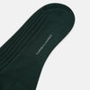 View 3 of product The Turnbull & Asser Olive Long Socks, featuring a ribbed texture, are shown over the calf on a plain white background—a refined addition to any men’s dress sock collection.