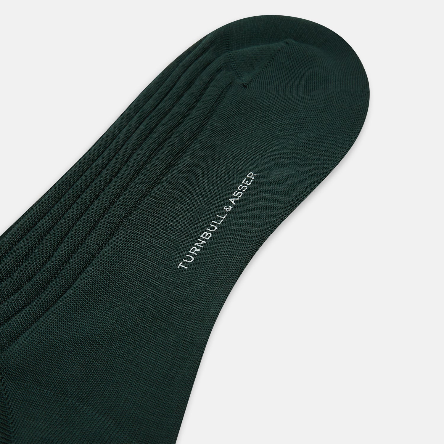 View 3 of product The Turnbull & Asser Olive Long Socks, featuring a ribbed texture, are shown over the calf on a plain white background—a refined addition to any men’s dress sock collection.