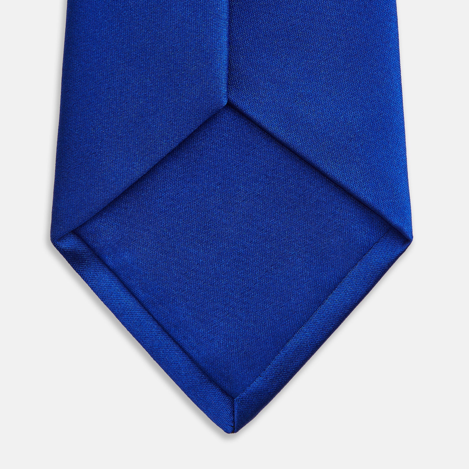 View 4 of product The Turnbull & Asser SATIN CRUISE TIE, in vibrant royal blue with a smooth, lustrous finish, creates a striking contrast against a plain white background.