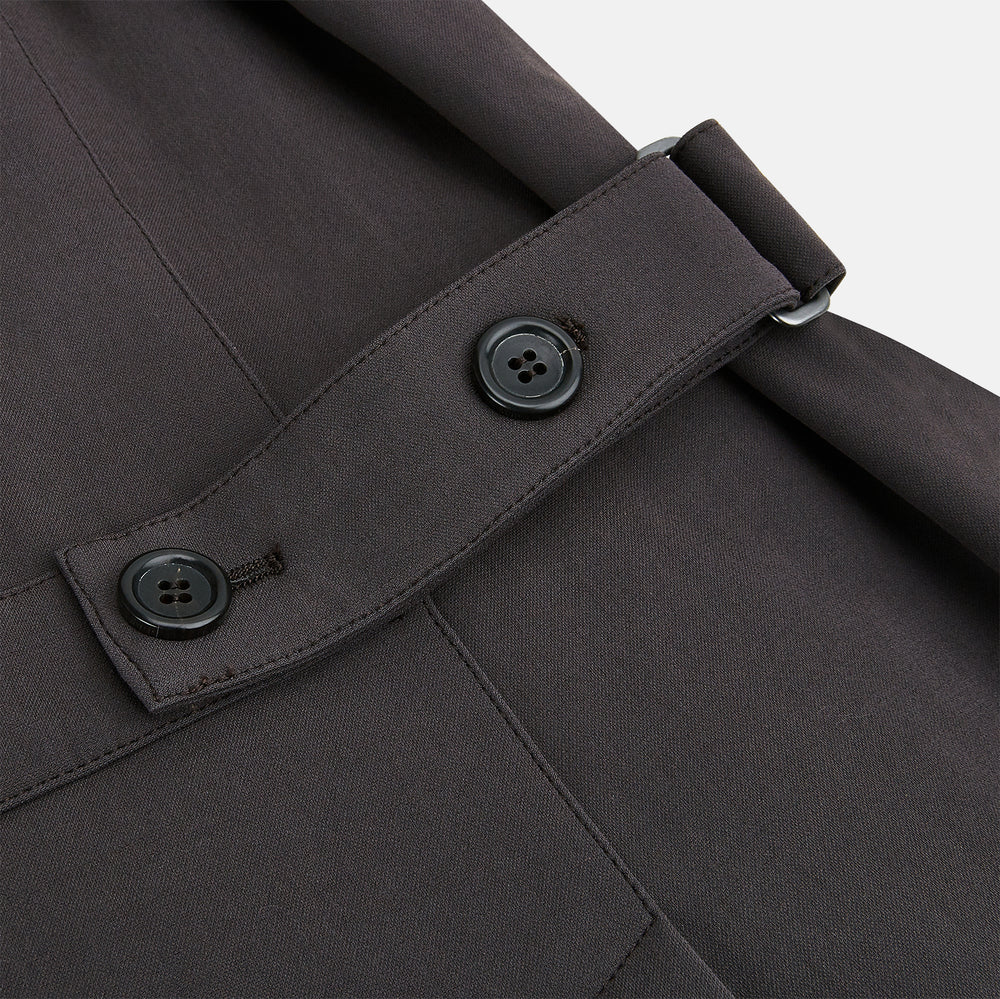 The Dark Chocolate John Arthur Trench Coat by Turnbull & Asser features a pointed collar, two large slanted side pockets, and a vertical chest pocket—a versatile 2-in-1 piece ideal for any occasion.