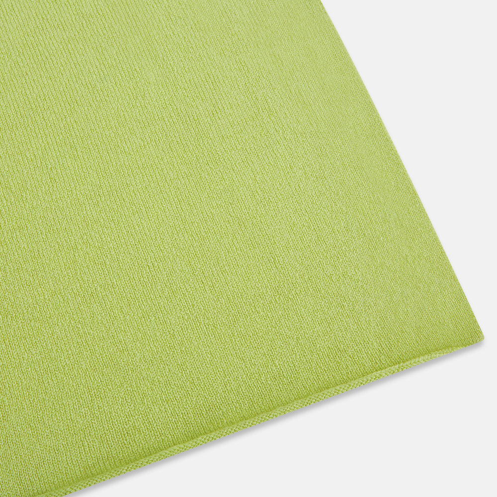 The Plain Canary Yellow Cashmere Knitted Scarf from Turnbull & Asser is a soft, premium accessory, elegantly draped against a white background—an essential addition to any wardrobe.