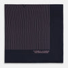 View 4 of product The Navy and Pink Stripe Silk Pocket Square by Turnbull & Asser features thin pink stripes, a geometric border, hand-rolled edges, and "TURNBULL & ASSER HAND PRINTED IN ENGLAND" printed in white.
