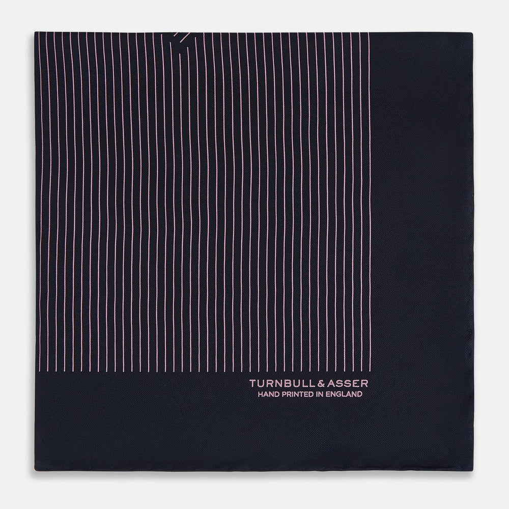 The Navy and Pink Stripe Silk Pocket Square by Turnbull & Asser features thin pink stripes, a geometric border, hand-rolled edges, and "TURNBULL & ASSER HAND PRINTED IN ENGLAND" printed in white.
