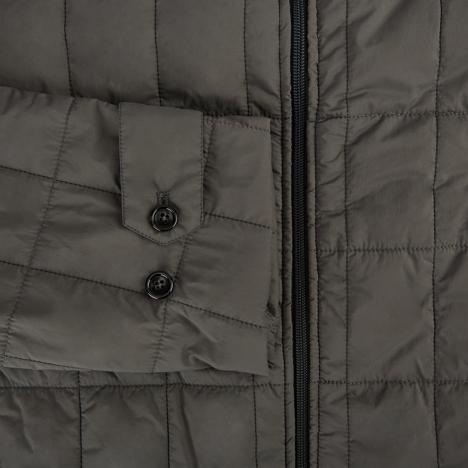 View 4 of product The Battersea Shadow Grey Quilted Jacket by Turnbull & Asser features a front zipper, buttoned cuffs, pointed collar, and multiple pockets—an ideal choice for the modern gentleman. Shown on a plain white background.