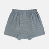 View 2 of product Turnbull & Asser Green Houndstooth Godfrey Boxer Shorts with an elastic waistband, showcasing a small black and white houndstooth pattern, are laid flat on a white background.