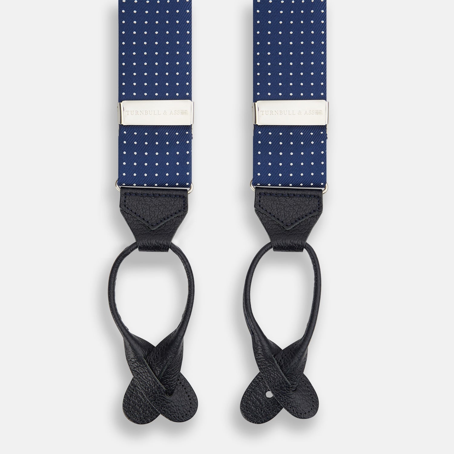View 1 of product Turnbull & Asser Navy & White Small Spot Adjustable Silk and Navy Leather Braces feature silver-engraved clips and leather button loops—perfect for refined sartorial style.