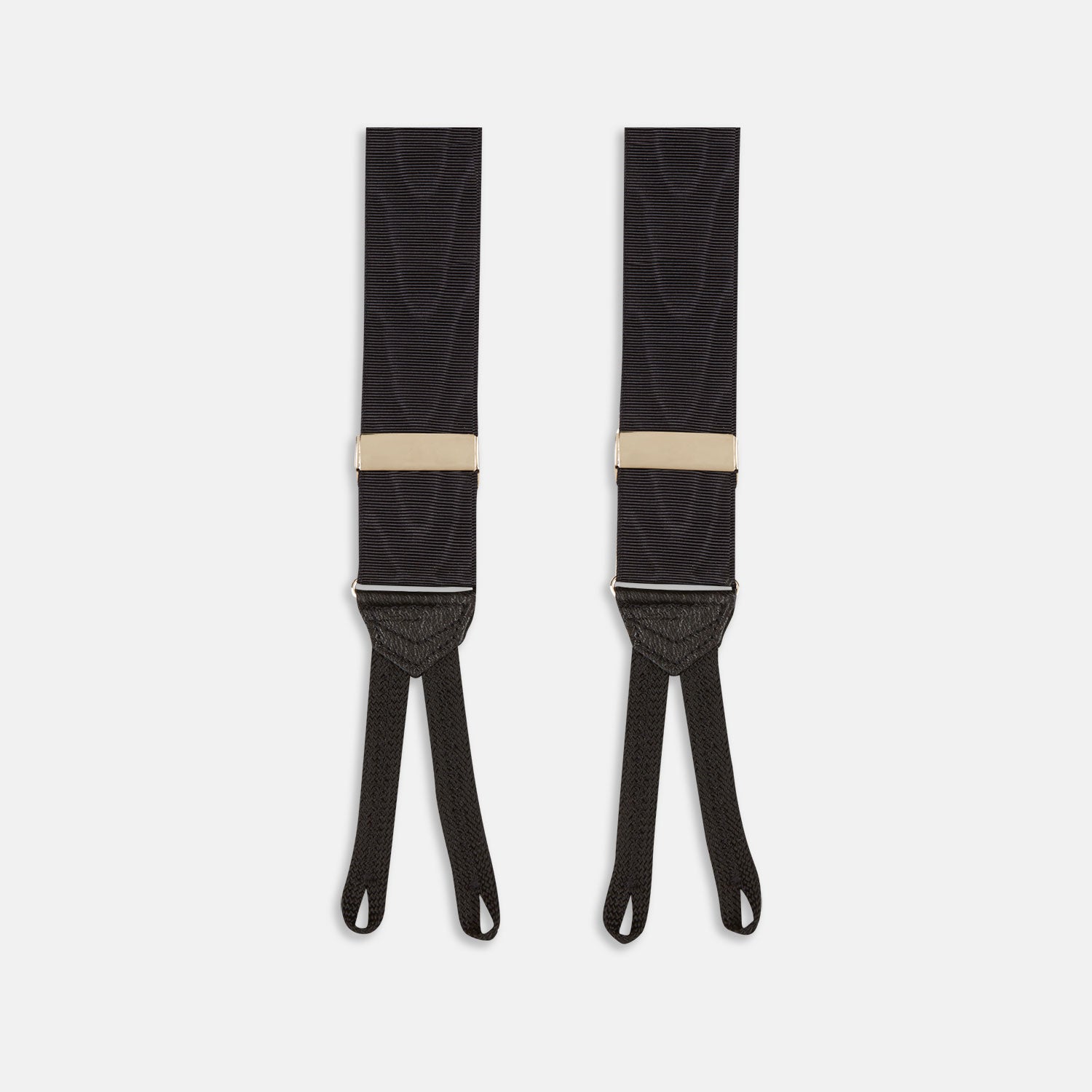 View 4 of product Turnbull & Asser Black Adjustable Formal Braces featuring leather ends and beige metal adjusters, made in England, shown on a white background.