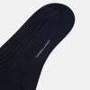 View 3 of product A single navy long sock by Turnbull & Asser, featuring a subtle ribbed texture and crafted from soft Egyptian cotton, displayed on a plain white background.