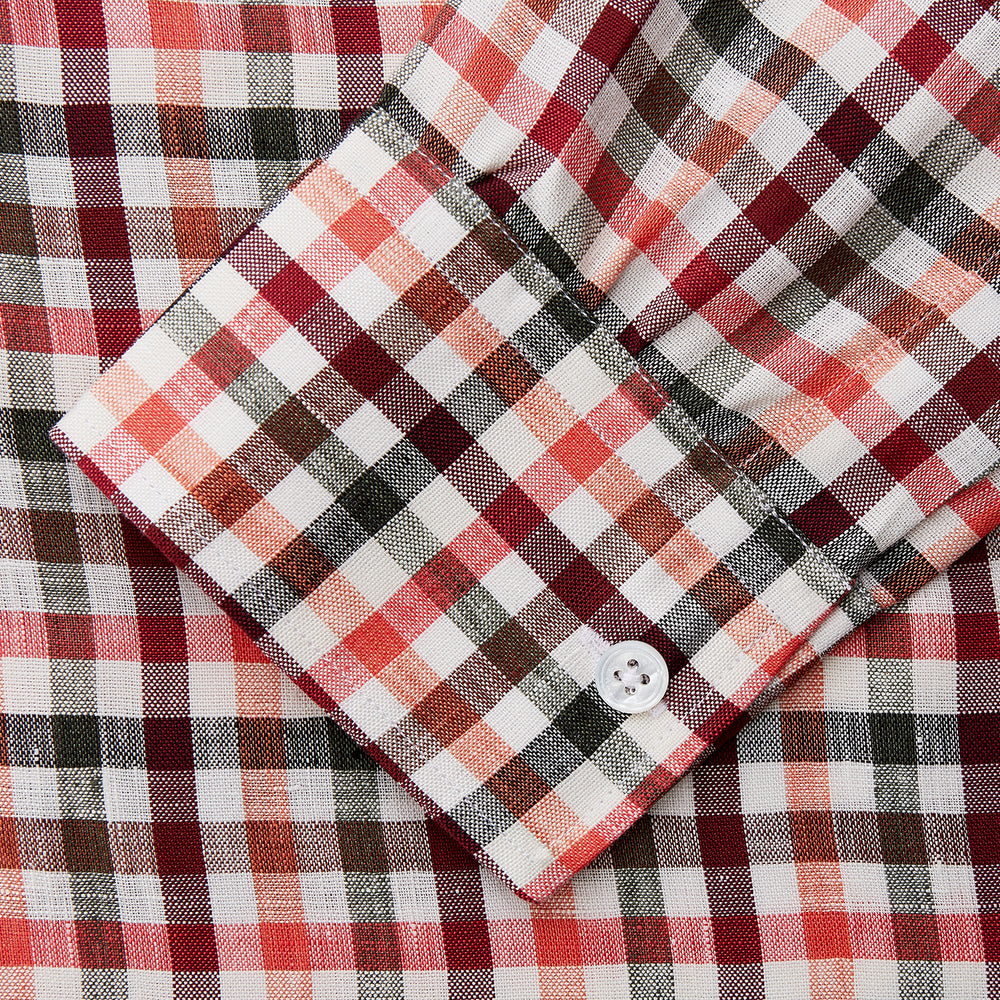 The Turnbull & Asser Red and Green Check Linen Blend Weekend Fit Hayne Shirt features a classic plaid pattern in red, white, black, and green, with a Dorset button-down collar and long sleeves. Displayed on a white background.