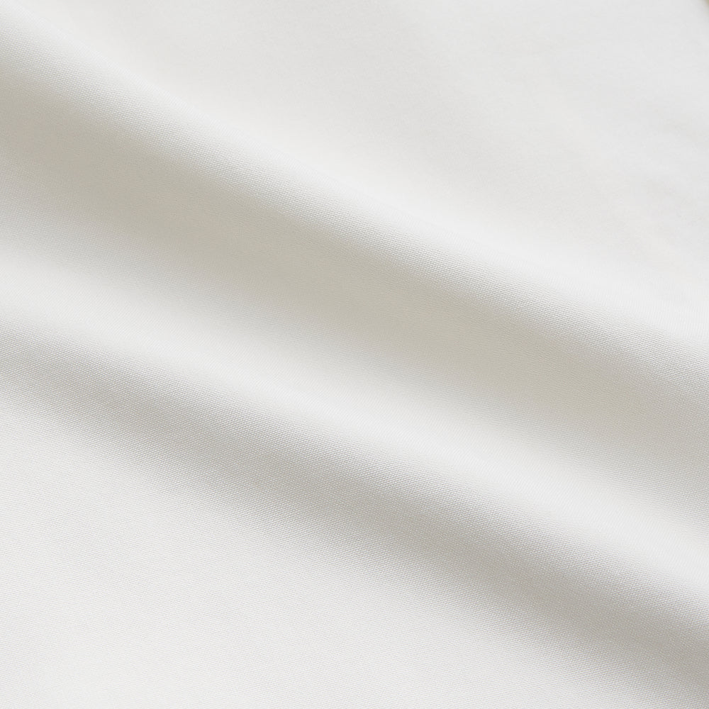 The Cream Silk Holiday Fit Phillips Shirt by Turnbull & Asser is a short-sleeved, collared silk shirt in off-white with three front pockets and a revere collar, displayed flat on a plain white background.
