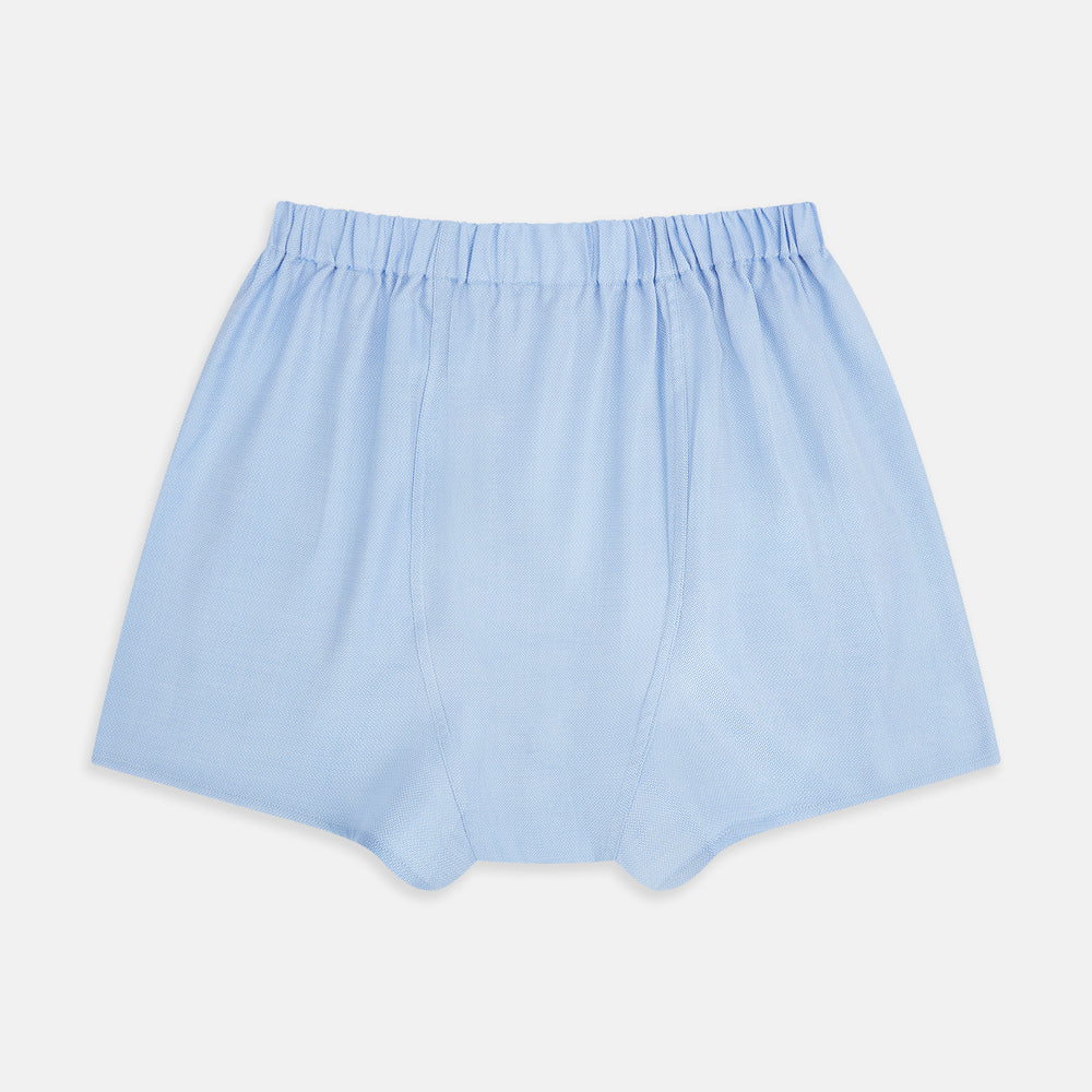 Plain Blue Godfrey Boxer Shorts by Turnbull & Asser, crafted from smooth Italian cotton. Featuring a light blue color and elastic waistband, these men's boxers are shown flat on a white background with a classic, pattern-free design.