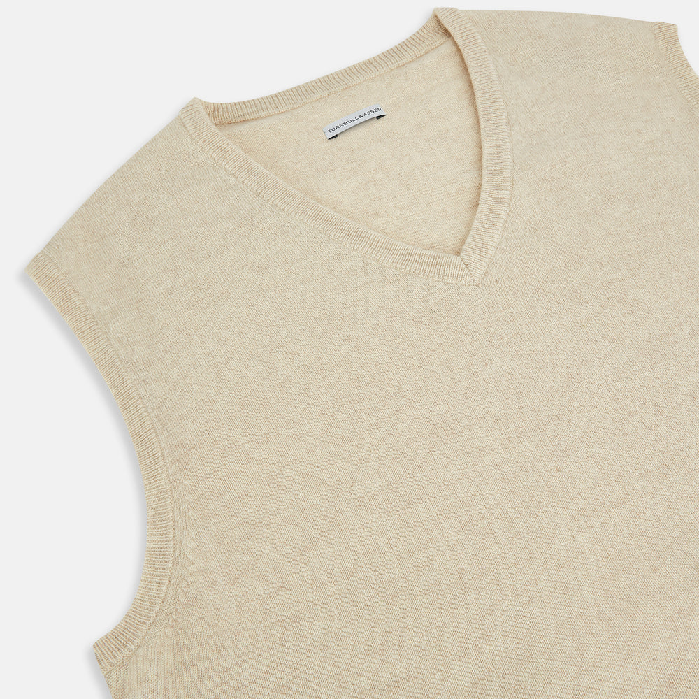 The Turnbull & Asser Cream Cashmere V-neck Vest features a sleeveless design and ribbed hem, presented on a plain white background—a refined update to the classic men’s sweater.