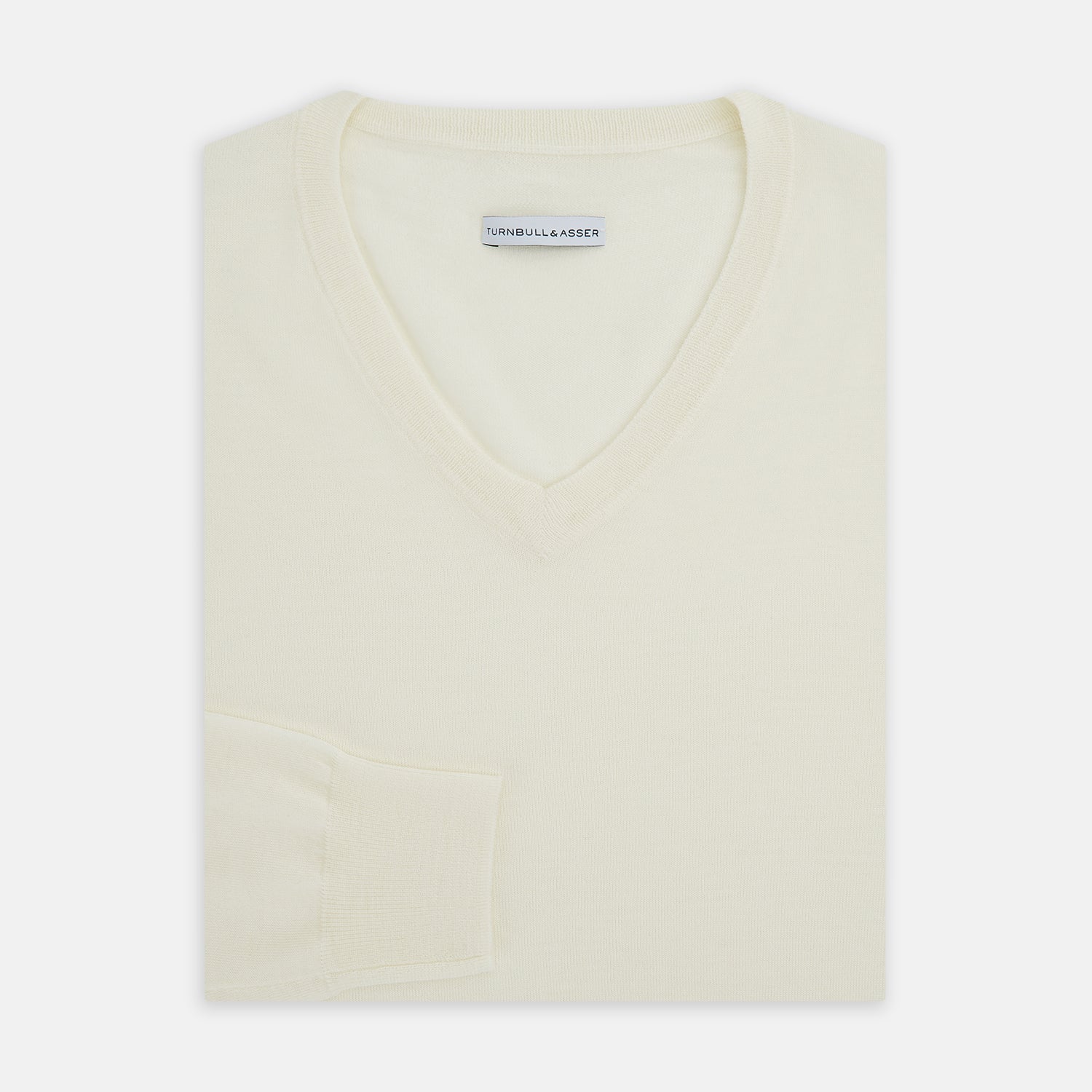 View 9 of product The Turnbull & Asser White Fine Merino V-Neck Jumper, shown against a white background, features a timeless design with long sleeves and ribbed cuffs and hem.