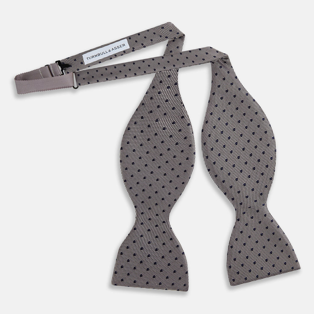 The Turnbull & Asser Navy and Silver Micro Dot Silk Bow Tie, featuring a refined dot pattern, is displayed on a white background.