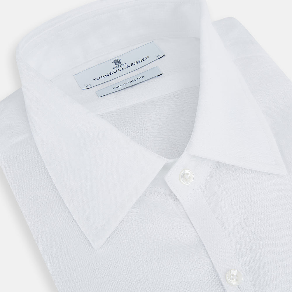 The White Linen Westminster Shirt by Turnbull & Asser features a classic Turnbull collar and button-down front, highlighting British craftsmanship against a plain white background.