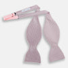 View 2 of product The Turnbull & Asser Pale Pink and White Square Silk Bow Tie features white stripes and subtle square patterns, ideal for formalwear. Shown on a white background.