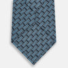 View 3 of product A rolled-up Turnbull & Asser Pale Blue and Navy Weave-Patterned Printed Silk Tie is shown against a white background.