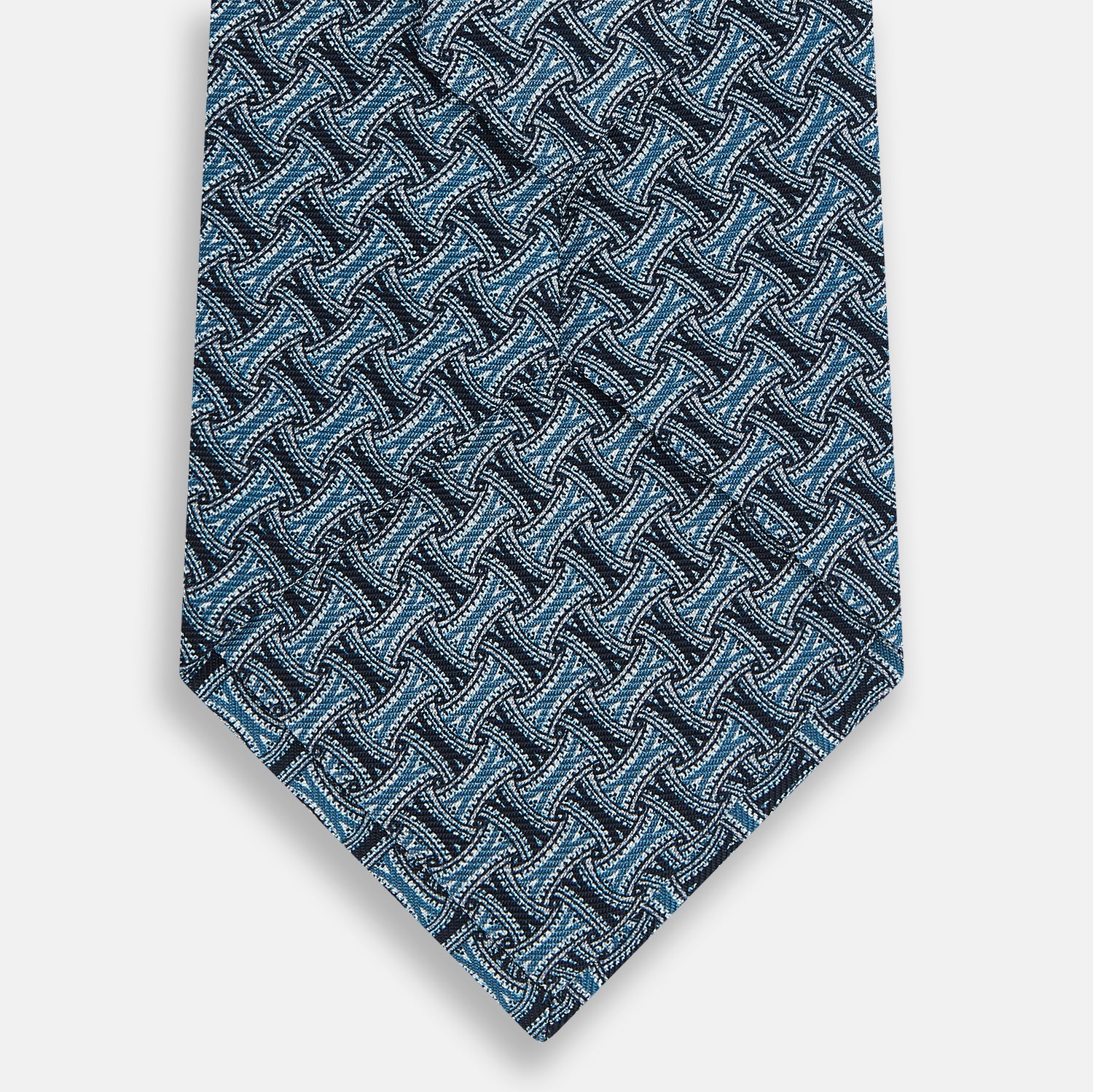 View 3 of product A rolled-up Turnbull & Asser Pale Blue and Navy Weave-Patterned Printed Silk Tie is shown against a white background.