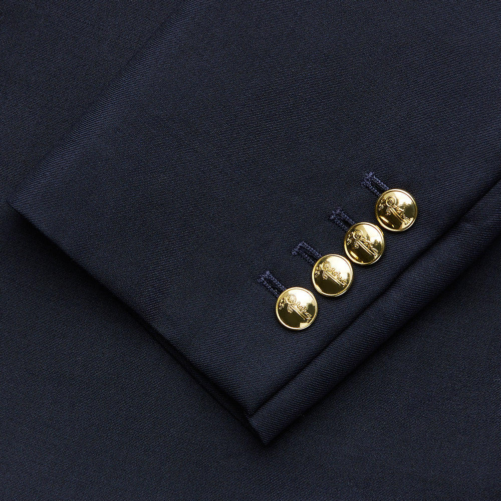 The Turnbull & Asser Short Navy Double Breasted Classic Blazer, featuring gold buttons, peaked lapels, and two front flap pockets, is displayed on a plain white background.