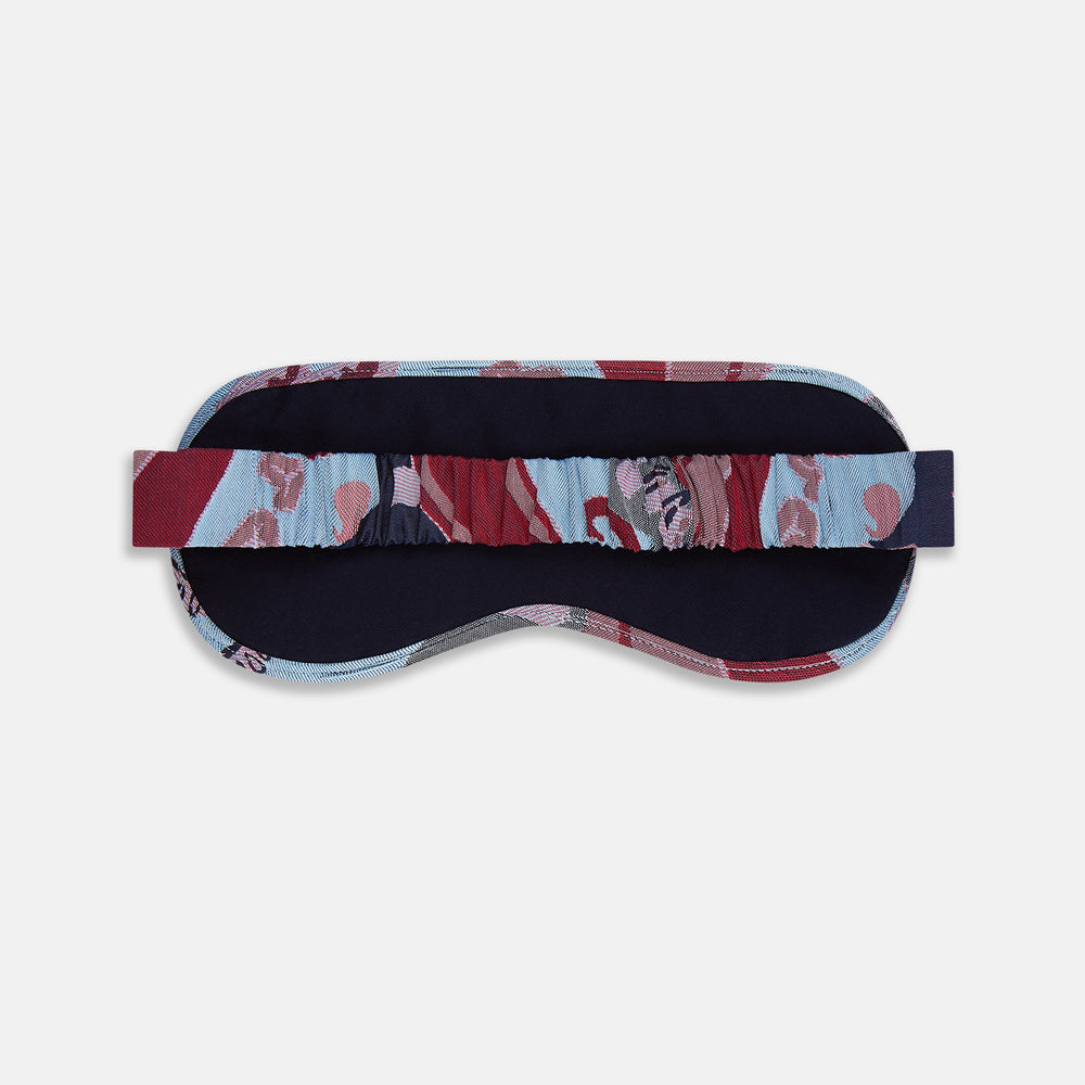 The Blue Bloomsbury Jacquard Cashmere Lined Sleep Mask and Bag by Turnbull & Asser features a blue and red abstract floral pattern, elastic strap, and is shown on a plain white background.
