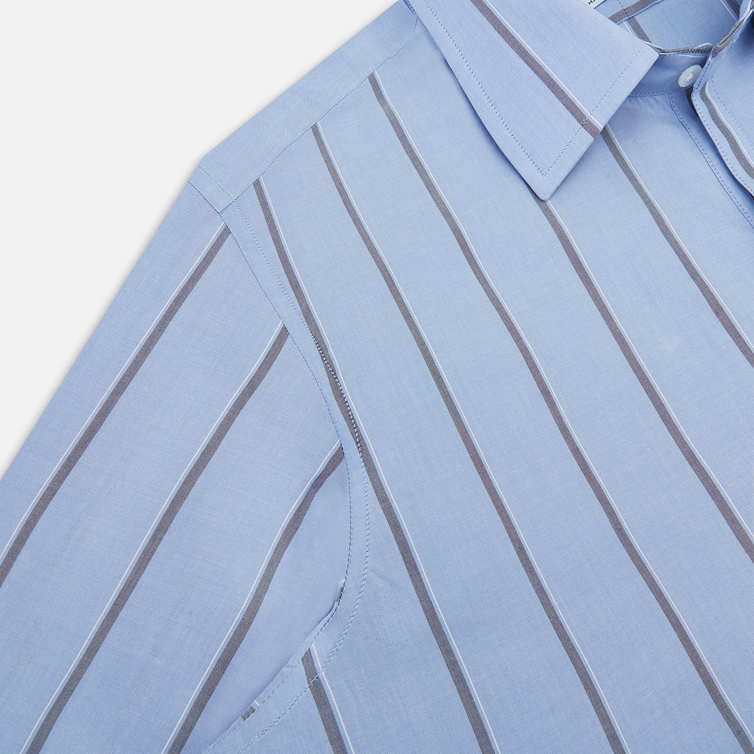 View 6 of product The Sky Blue Track Stripe Westminster Shirt by Turnbull & Asser features long sleeves, a Turnbull collar, and vertical dark blue and white stripes, displayed flat on a white surface.