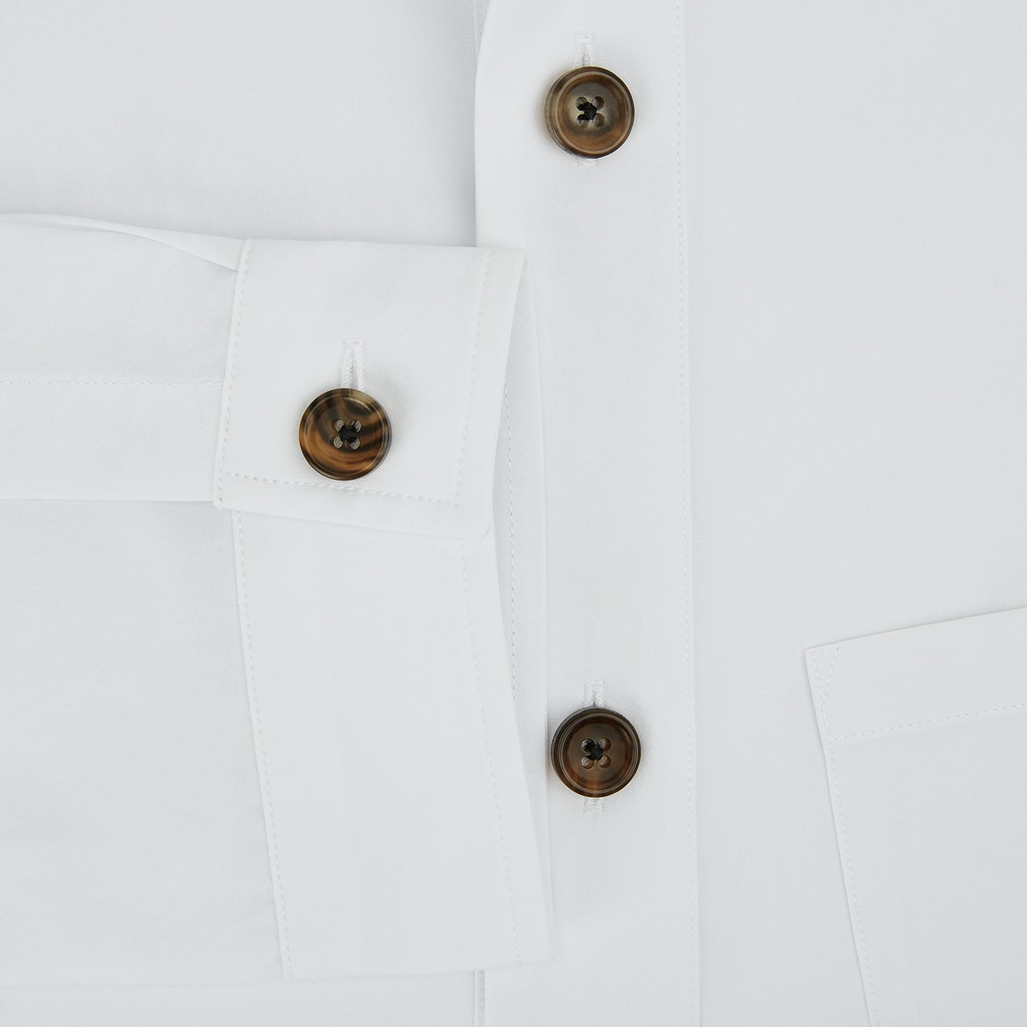 View 4 of product The White Hyde Overshirt by Turnbull & Asser is crafted from sanforised cotton with a left chest pocket and dark buttons—offering a sharp, casual blazer alternative. Shown laid flat on a white background.