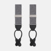 View 1 of product The Turnbull & Asser Silver Paisley Adjustable Silk Braces feature gray paisley silk with silver fittings and black leather ends, offering refined style. The symmetrical braces are displayed flat on a white background.